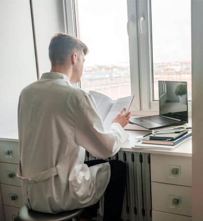 Studio shot of young doctor guy student in the clinic in practiceの写真素材