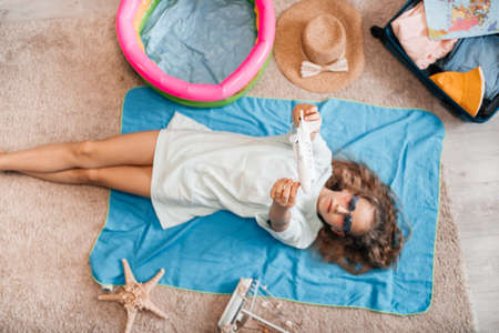 woman tuck at quarantine at home dreaming about sea beach vacation.の写真素材