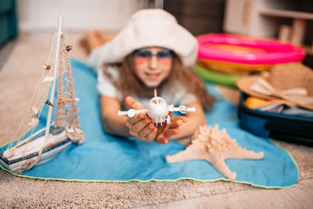 woman tuck at quarantine at home dreaming about sea beach vacation.の写真素材