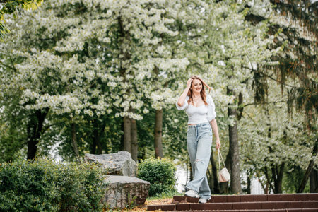 Spring Nature. Tender woman portrait in blooming emerald garden. smiling happy cute girl with lifestyle activity outdoor.の写真素材