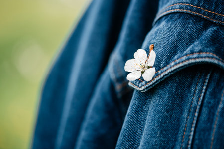 Active girl in retro dress and denim jacket in a blooming apple orchard. lifestyle activity outdoor.