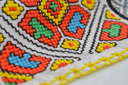 Geometric multi-colored pattern on a white fabric embroidery