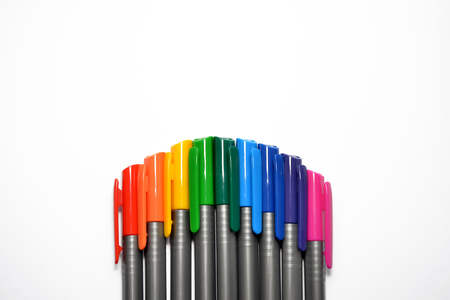 Set of rainbow pens, lying exactly in the form of an arc at the bottom side of the photo, with copyspaceの写真素材