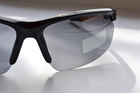 Test of a sport sunglasses with photochromic effect on the sunshine, the place where the sticker wasの写真素材