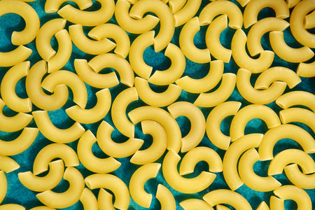 Dry pasta horns on blue backgroundの写真素材