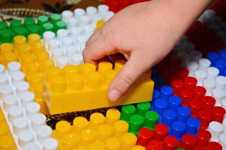 Baby playing and discovery with colorful toys at home, close-up detail. Child plays with plastic...