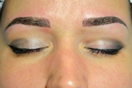The finished result of microblading, dark eyebrows, permanent makeup on eyebrows.の写真素材