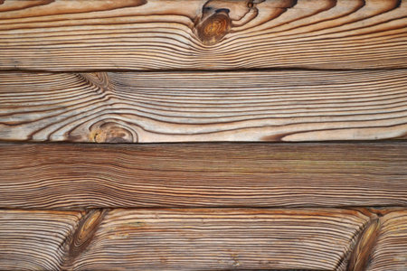 Wooden background, contrast structure of burnt wood with knots, in form of horizontal boards