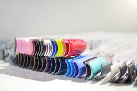 Samples of colors gel nail polish in the sunlight, bright picture with copyspace closeupの写真素材