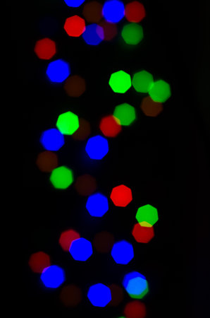 Multicolored blurred bokeh lights, on a black backgroundの写真素材
