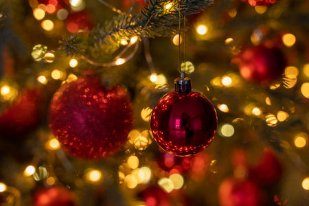 Background image for postcards, Christmas tree closeup, with golden balls and a yellow lightsの写真素材