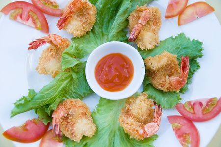 fresh and tasty salad from tomatoes and roasted prawns with sauceの写真素材