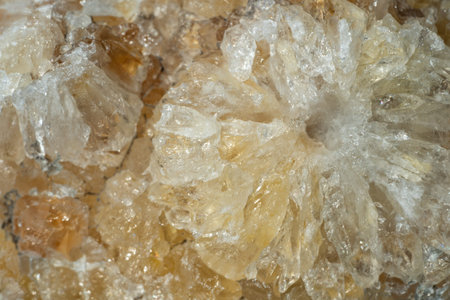 Macro shot of a sample of natural stone - untreated citrine (yellow quartz). The stone grows in the...