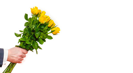 a man gives a bouquet of flowers. a close-up of a mans hand holds a bouquet