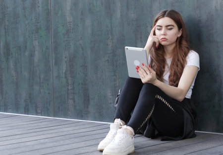 A beautiful student girl using a computer, laptopの写真素材