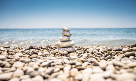 A pyramid of rounded stones of various shapes, sizes and shades. The stones lie one on top of the...