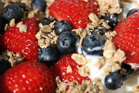 Fresh crunchy granola with nuts, berries and yogurt for healthy breakfast, close up, horizontalの写真素材