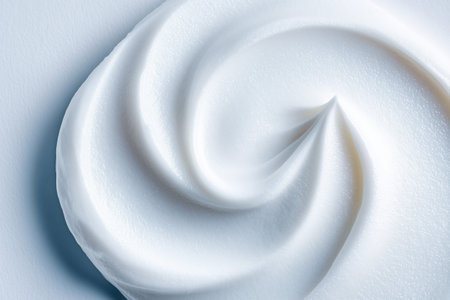 Minimal abstract white cosmetic cream texture with smooth spiral swirl and soft glossy surface inspired by Japanese anime aesthetics for premium skincare branding and luxury beauty backgroundの素材
