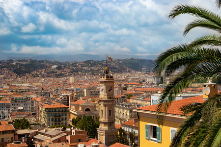 View of colorful houses and a cathedral with the bell tower Nice on a sunny day. France.の写真素材