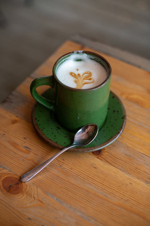 Cup of coffee latte art on wooden table in coffee shopの写真素材