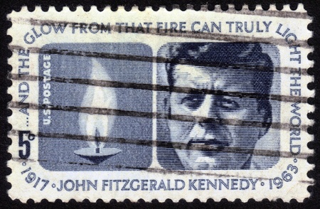 UNITED STATES OF AMERICA - CIRCA 1964: a stamp printed in the United States of America shows President  John Fitzgerald Kennedy (1917-1963) and Eternal Flame, circa 1964のeditorial素材
