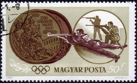 HUNGARY - CIRCA 1965  stamp printed by Hungary, shows two medals, shooting, Summer Olympics in Tokyo, series, circa 1965のeditorial素材