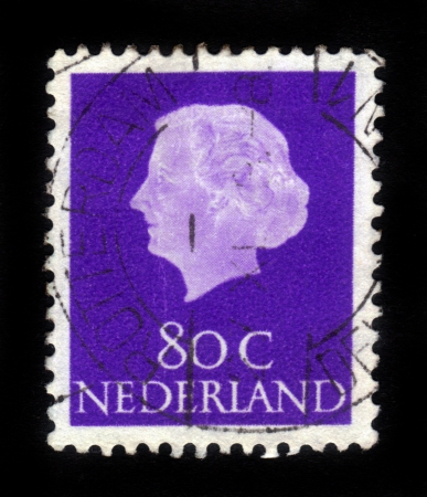 NETHERLANDS - CIRCA 1953: A stamp printed in Netherlands shows portrait of Queen regnant of Netherlands Juliana Louise Emma Marie Wilhelmina on a blue background ,circa 1953のeditorial素材
