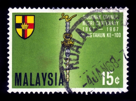 MALAYSIA - CIRCA 1967  A stamp printed in Malaysia shows Coat of arms of Sarawak , Ulang Tahun ke 100  100th anniversary , circa 1967のeditorial素材
