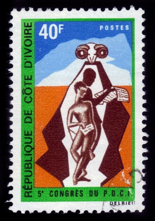 COTE D IVOIRE - CIRCA 1970  A stamp printed in Republic Cote d Ivoire shows two indigenous inhabitants and head of spiral-horned sheep , devoted 5 Congress of Democratic Party , circa 1970のeditorial素材