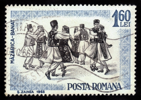 ROMANIA - CIRCA 1965: A stamp printed by Romania, shows folk dancers of Romania,  Banat region is the Southwestern region of Romania , circa 1965のeditorial素材