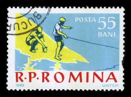 ROMANIA - CIRCA 1962: A stamp printed in the Romania shows boys on a fishing trip, circa 1962.の写真素材