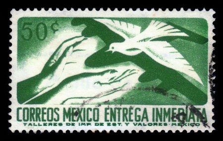 MEXICO - CIRCA 1969: A Stamp printed in Mexico shows hands of people who are ready to accept the white dove, circa 1969のeditorial素材