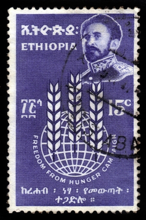 ETHIOPIA - CIRCA 1963 : A stamp printed in Ethiopia shows image of  emperor Haile Selassie on a blue background , with the inscription : freedom from hunger campaign, circa 1963のeditorial素材