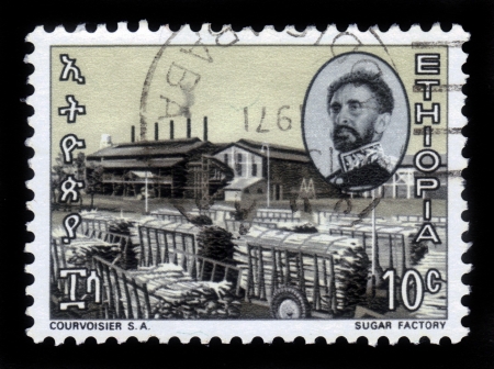 ETHIOPIA - CIRCA 1971   A stamp printed in Ethiopia shows portrait of emperor Haile Selassie and sugar factory , with the inscription in amharic , series, circa 1971のeditorial素材