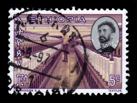 ETHIOPIA - CIRCA 1971   A stamp printed in Ethiopia shows portrait of emperor Haile Selassie and textile factory , with the inscription in amharic , series, circa 1971のeditorial素材