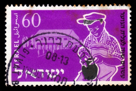 ISRAEL - CIRCA 1955  A stamp printed in Israel, shows young boy being trained, to potter s craft ,  issued in honor of 20th anniversary of Youth Aliyah , training of the crafts, series, circa 1955の写真素材