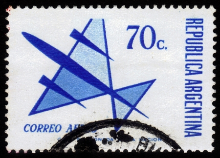 ARGENTINA - CIRCA 1963: A stamp printed in Argentina shows flight of symbolic airplane , blue, circa 1963の写真素材