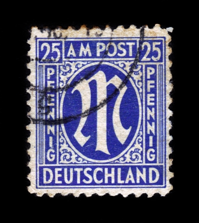 GERMANY - CIRCA 1945: A stamp printed in American-British occupation zone shows definitive stamp series "M" in denomination of 25 pfennig, circa 1945のeditorial素材