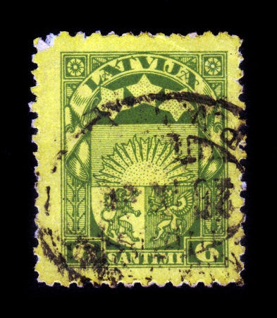 LATVIA - CIRCA 1932  A stamp printed in Latvia shows latvian coat of arms, circa 1932のeditorial素材