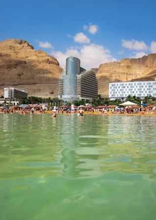 Dead Sea, Ein Bokek, Israel - May 28  vacationers and tourists bathe in the Dead Sea on the background of luxury hotels, on May 28, 2014 in Ein Bokek, Dead Sea, Israelのeditorial素材