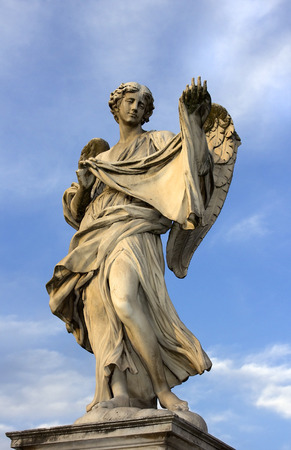 statue of an angel standing on the bridge leading to the Castle Sant Angelo against the blue sky, Romeのeditorial素材
