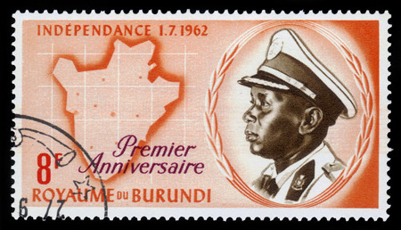 Burundi - CIRCA 1963: A stamp printed by Burundi shows portrait of King Mwami Mwambutsa IV and map of Burundi, circa 1963のeditorial素材