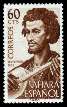 SPANISH SAHARA - CIRCA 1953: stamp printed by Spain, shows man musician, issue to benefit the children welfare fund,  circa 1953のeditorial素材
