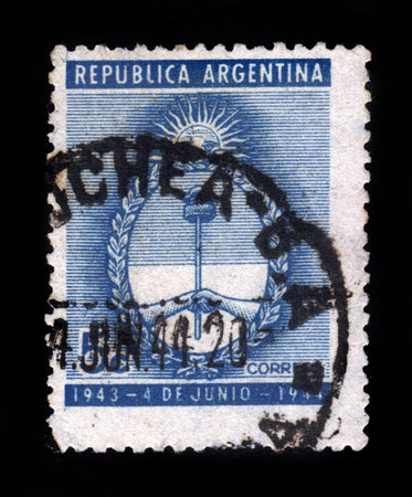 A stamp printed in the Argentina, shows coat of arms, dedicated to the first anniversary military putsch, circa 1944の写真素材
