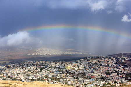 rainbow over the arab village Cana of Galilee ( Kafr Kanna ) in Israel , place where Christ showed first miracleの写真素材