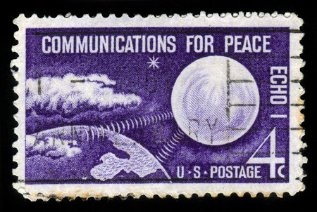 UNITED STATES - CIRCA 1960: A stamp printed in the United States, shows radio waves connecting Echo I and Earth, with inscription communication for Peace, circa 1960のeditorial素材