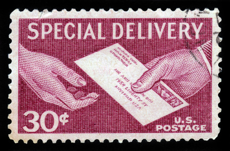 UNITED STATES OF AMERICA - 1957: A stamp printed in the USA shows hands and letter, postal service for special delivery of letters, 1957のeditorial素材
