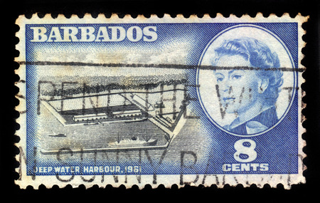 BARBADOS - CIRCA 1961: a stamp printed in Barbados shows Deep Water Harbour ( Port of Bridgetown ) and portrait of Queen Elizabeth II, circa 1961のeditorial素材