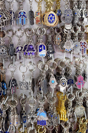 keychains, hamsa - traditional palm-shaped amulet popular the Middle East and North Africa, used as a sign of protection against the evil eye in the Jewish tradition on a market in Jerusalem, Israelの写真素材