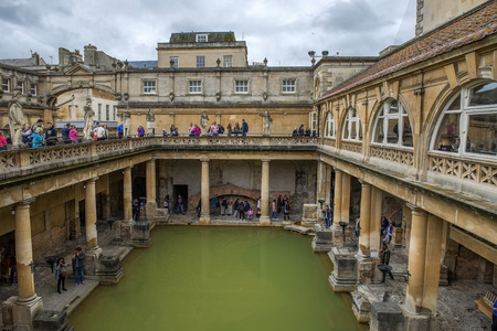 BATH, ENGLAND - July 27, 2015: Tourists at the ancient Roman Bath Museum, West England on July 27, 2015 The Roman baths are the most famous tourist attraction in the city of Bathのeditorial素材